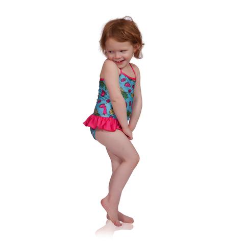 FASTEN swimsuit, Fruitsicle cross-back swimsuit with ruffle for baby and toddler girls. Features patented design that opens at the waist, making bathroom breaks and baby diaper changes faster and easier. Sizes 6m-5. UPF 50 sun protection built right in! Cross-back swimsuit design. Cute fruit pattern with ruffle. 