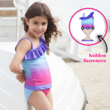 Girl at Beach wearing Fuchsia Turquoise Ombre one-shoulder swimsuit for girls by FASTEN. Features patented design that opens at the waist, making bathroom breaks and baby diaper changes faster and easier. Sizes 2T-10. UPF 50  sun protection built right in! One-shoulder design. Ombre varies slightly in each swimsuit.